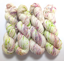 Load image into Gallery viewer, Lime and purple speckles on superwash merino slub, chunky weight yarn.
