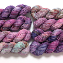 Load image into Gallery viewer, Pinks and purples gradient yarn set on a superwash merino/nylon/sparkle sock yarn.
