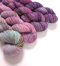 Load image into Gallery viewer, Pinks and purples gradient yarn set on a superwash merino/nylon/sparkle sock yarn.
