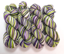 Load image into Gallery viewer, Beetlejuice on superwash Merino/nylon/sparkle sock yarn.
