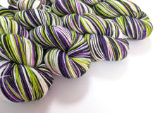 Load image into Gallery viewer, Beetlejuice on superwash Merino/nylon/sparkle sock yarn.
