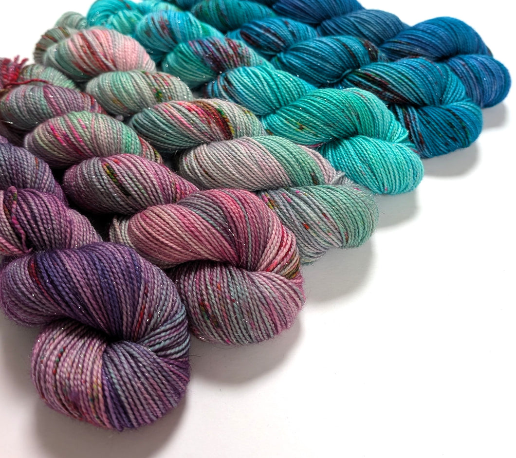 Multi coloured gradient yarn set on superwash merino/nylon/sparkle sock yarn.