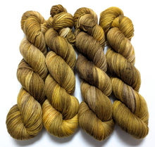 Load image into Gallery viewer, Old Gold on superwash merino/cashmere/nylon sock yarn.
