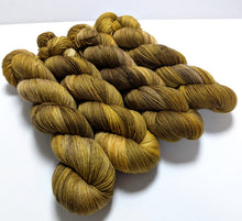 Load image into Gallery viewer, Old Gold on superwash merino/cashmere/nylon sock yarn.
